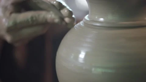 Potter working on potters wheel making ceramic pot from clay in pottery workshop Stock Footage 158971217