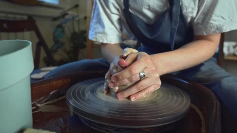 Potter working on a Potter's wheel making a vase Stock Footage 278310847