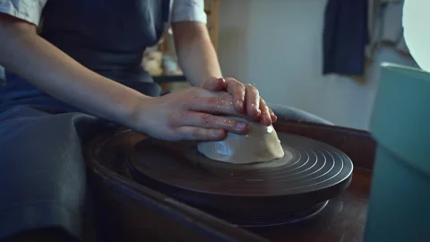 Potter working on a Potter's wheel making a vase Stock Footage 278310850