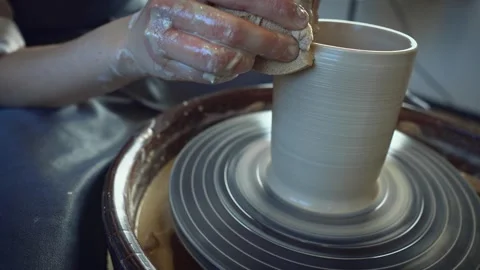 Potter working on a Potter's wheel making a vase Stock Footage 278310899