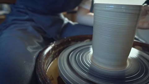 Potter working on a Potter's wheel making a vase Stock Footage 278310949