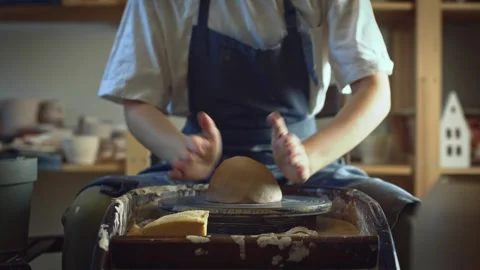 Potter working on a Potter's wheel making a vase Stock Footage 278311053