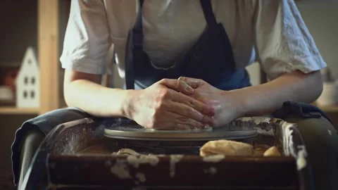 Potter working on a Potter's wheel making a vase Stock Footage 278311109