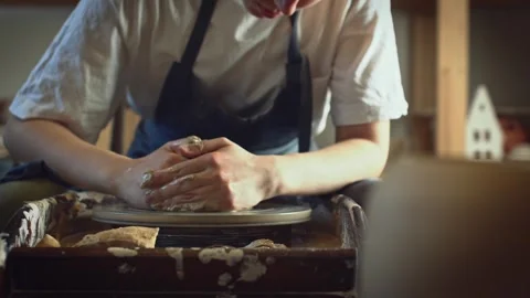 Potter working on a Potter's wheel making a vase Stock Footage 278311147