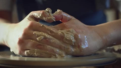 Potter working on a Potter's wheel making a vase Stock Footage 278311190