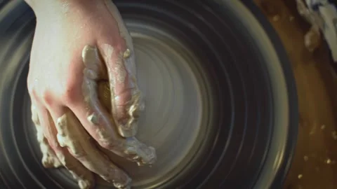 Potter working on a Potter's wheel making a vase Stock Footage 278311239