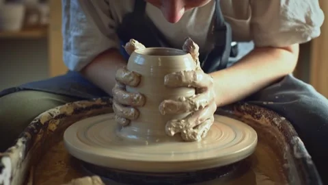 Potter working on a Potter's wheel making a vase Stock Footage 278311249