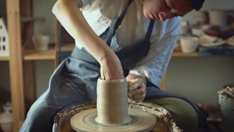 Potter working on a Potter's wheel making a vase Stock Footage 278311260