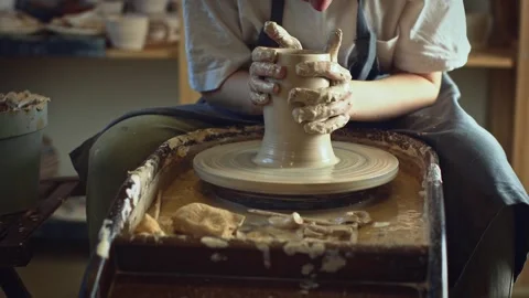 Potter working on a Potter's wheel making a vase Stock Footage 278311275