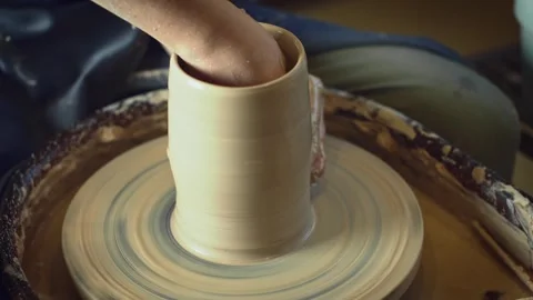 Potter working on a Potter's wheel making a vase Stock Footage 278311289