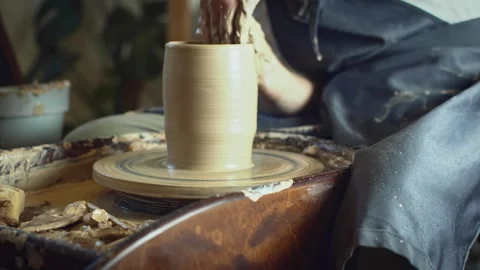 Potter working on a Potter's wheel making a vase Stock Footage 278311298
