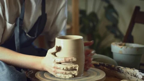 Potter working on a Potter's wheel making a vase Stock Footage 278311304