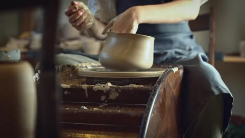 Potter working on a Potter's wheel making a vase Stock Footage 278311310