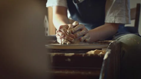 Potter working on a Potter's wheel making a vase Stock Footage 278311364