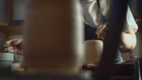 Potter working on a Potter's wheel making a vase Stock Footage 278311379