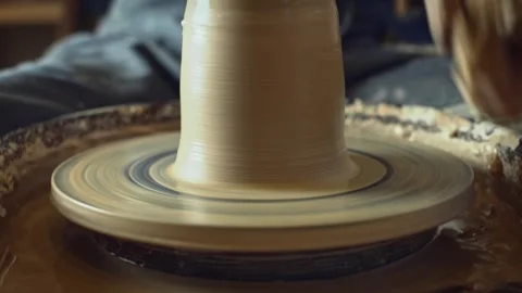 Potter working on a Potter's wheel making a vase Stock Footage 278311415