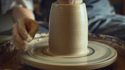 Potter working on a Potter's wheel making a vase Stock Footage 278311453