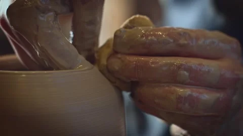 Potter working on a Potter's wheel making a vase Stock Footage 278311494