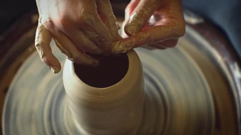 Potter working on a Potter's wheel making a vase Stock Footage 278311629