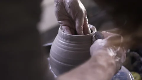Potter working in studio throwing pots on wheel Stock Footage 235466267