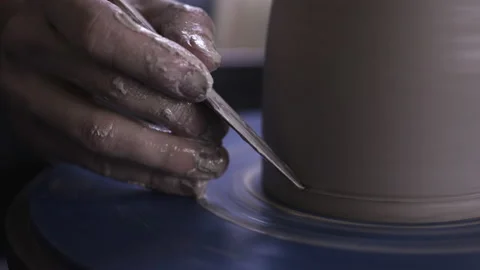 Potter working in studio throwing pots on wheel Stock Footage 235466285