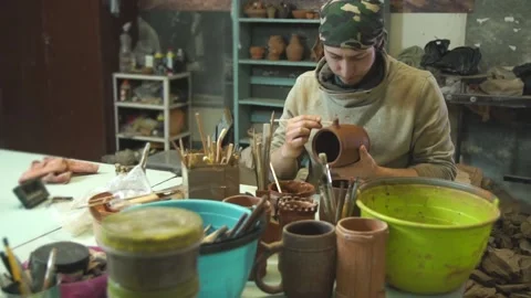 Potter works with clay in authentic workshop. Stock Footage 130803910
