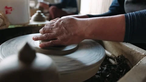 Potter works with clay on workshop. Working process in ceramic workshop. Potter Stock Footage 325299345