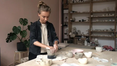 Potter in the workshop creates a decorative pot Video stock 107581793