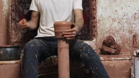Potter's hand making ceramic pot on the twisted pottery wheel. Video stock 245267993