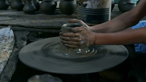 Potters hands are creating a jar or vase of earthenware on potters wheel Stock Footage 124976212