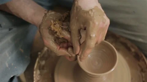 Potters hands close up making creating ceramic jar vase pot on pottery wheel  스톡 동영상 87450022