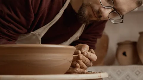Potter's hands covered with clay making beautiful bowl. Potter at work. Video stock 249935190