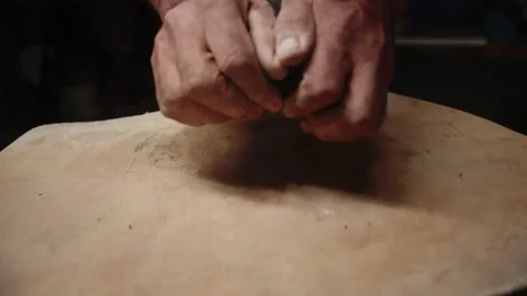 Potter's hands knead the clay on table with special napkin and prepare it for Stock Footage 159126007