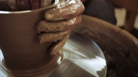 The potter's hands make a beautiful smooth pot on a potter's wheel. Stock Footage 162720545