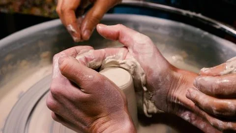 A potter's hands transform a lump of white clay into a beautiful piece of p.. Stock Photos