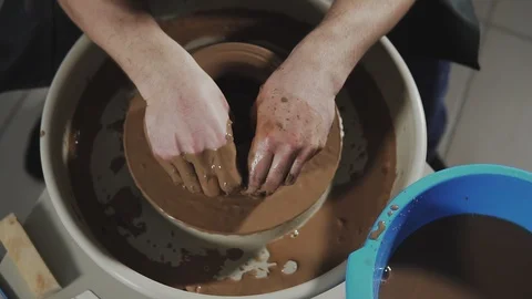 Potter's hands work with clay. Potter shapes clay product with pottery tools Stock Footage 114314254