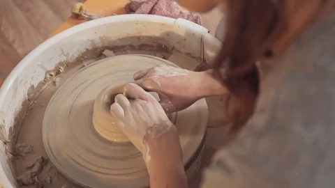Potter's hands work with clay on a potter's wheel. Close up Stock-Footage 83551413