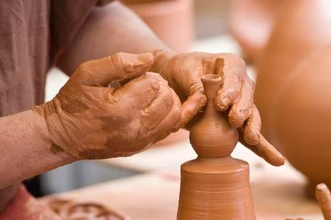 Potter's hands working. Stock Photos