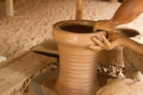 Potter's hands working on a pot Stock Photos