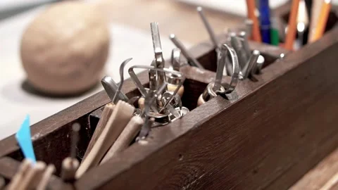 Potter's tools and piece of clay on ceramic workshop table Stock Footage 201568441