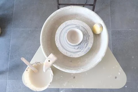 A potter's wheel and a sponge for working on a gray background Stock Photos