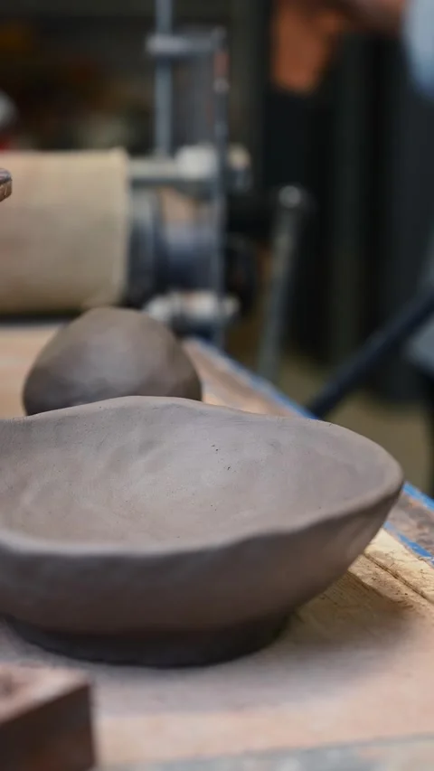 Potter's wheel for hand work, Master makes a plate by hand Stock Footage 293606737