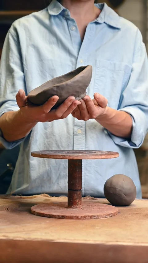 Potter's wheel for hand work, Master makes a plate by hand Stock Footage 293606767