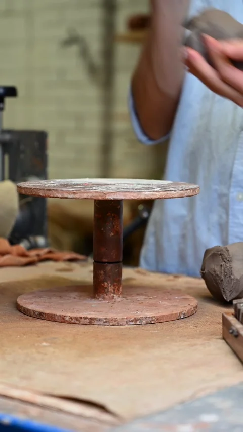 Potter's wheel for hand work, Master makes a plate by hand Stock Footage 293607055