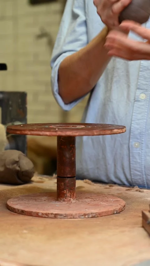 Potter's wheel for hand work, Master makes a plate by hand. Vertical format Stock Footage 293738481