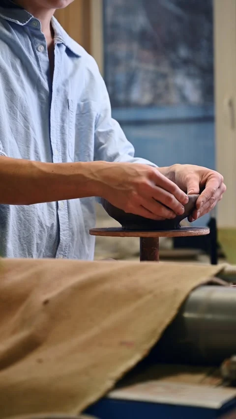 Potter's wheel for hand work, Master makes a plate by hand. Vertical format Stock Footage 293738683