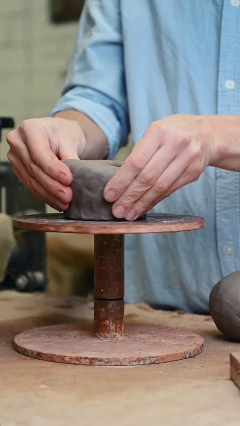 Potter's wheel for hand work, Master makes a plate by hand. Vertical format Stock Footage 293738714