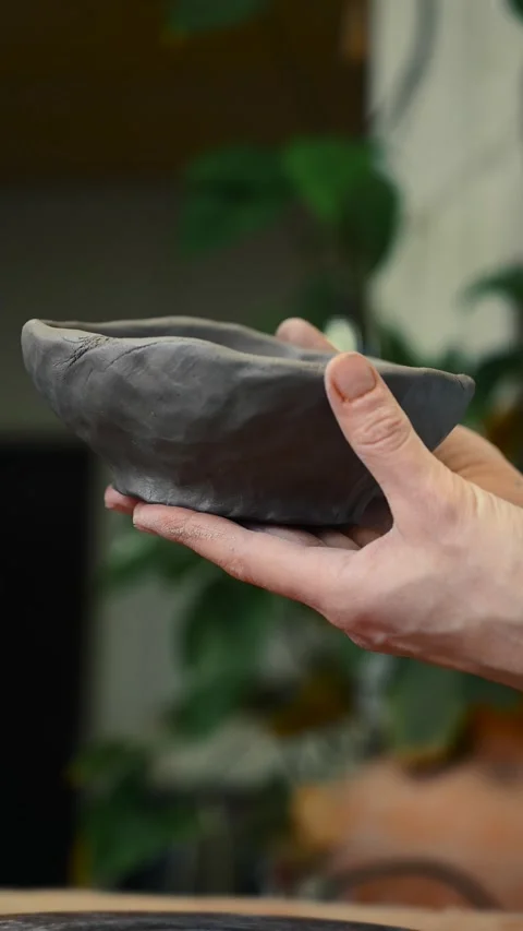 Potter's wheel for hand work, Master makes a plate by hand. Vertical format Stock Footage 293956915