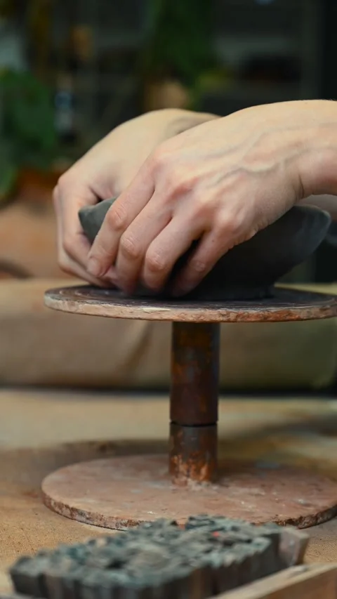 Potter's wheel for hand work, Master makes a plate by hand. Vertical format Stock Footage 293956923