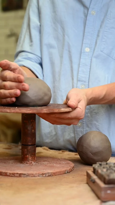 Potter's wheel for hand work, Master makes a plate by hand. Vertical format Stock Footage 293956928